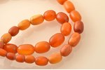 beads, amber, 57.27 g., the item's length 65 cm, largest stone size 2.9 x Ø2.15 cm...
