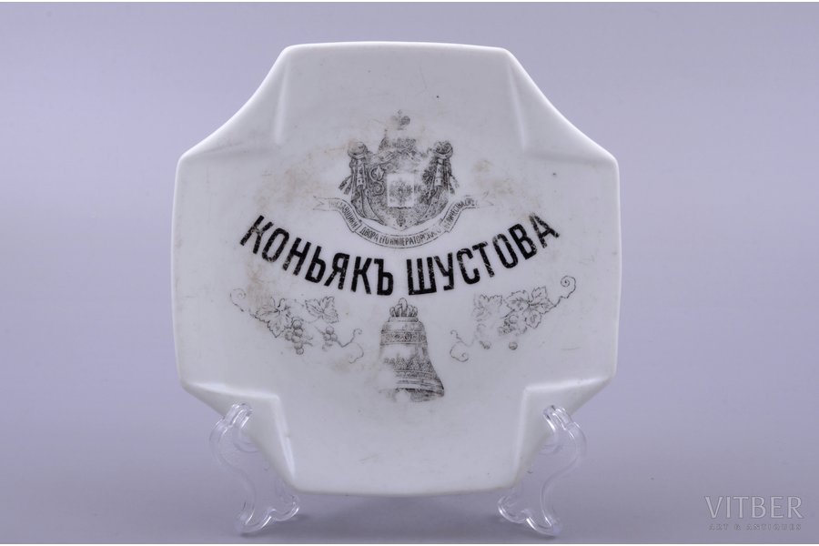 decorative table plaque, advertisment "Shustov's Cognac", porcelain, M.S. Kuznetsov manufactory, Russia, 1891-1917, 13.4 x 13.2 cm, Dmitrov factory, spider web-shaped cracks under the factory mark