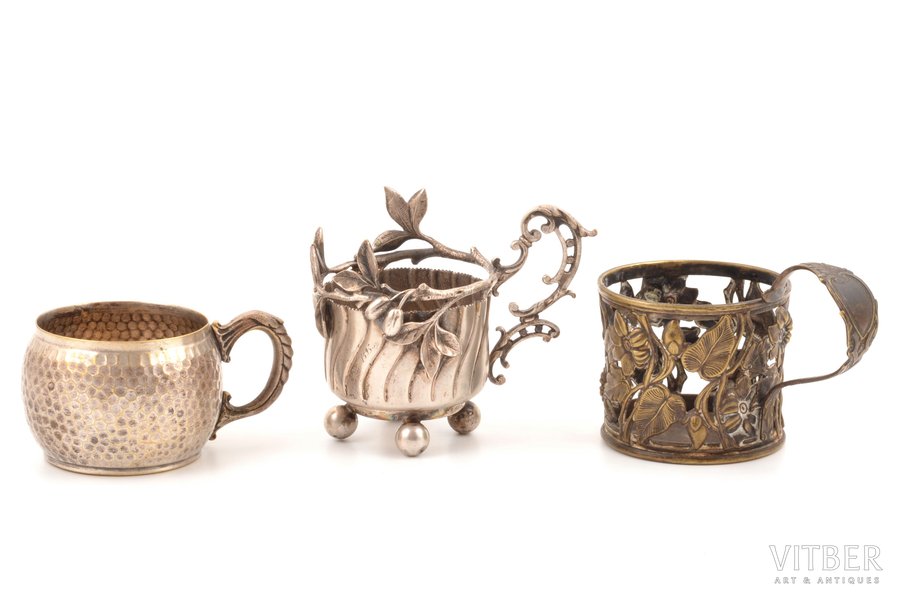 set of 3 tea glass-holders: Plewkiewicz w Warszawie, Fabr. Wolska, 1 tea glass-holder without hallmark, silver plated, metal, Russia, Congress Poland, the border of the 19th and the 20th centuries, Ø (inside) 6.1-6.6 cm, h 5.3 cm / Ø (inside) 7 cm, h (with handle) 7.8 сm / Ø (inside) 6.3 cm, h (with handle) 9.5 cm