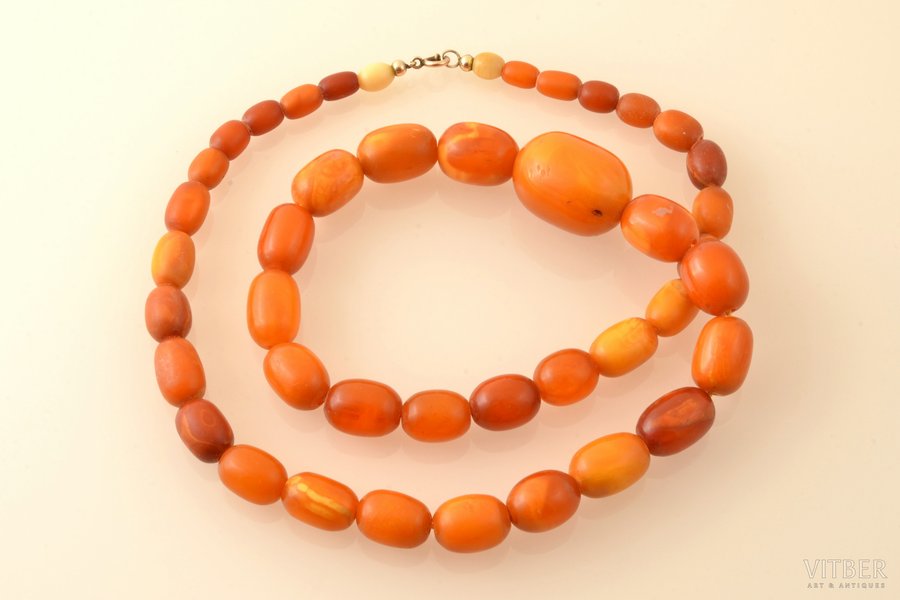 beads, amber, 57.27 g., the item's length 65 cm, largest stone size 2.9 x Ø2.15 cm