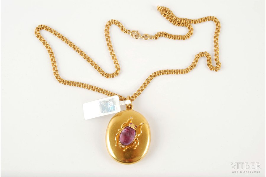 "Skarab", with a chain, by Arnd Samuel, gold, 56 standard, 29.2 g., amethyst, diamonds, ruby, the 19th cent., Russia, medallion weight 19.85 g, chain weight 9.35 g